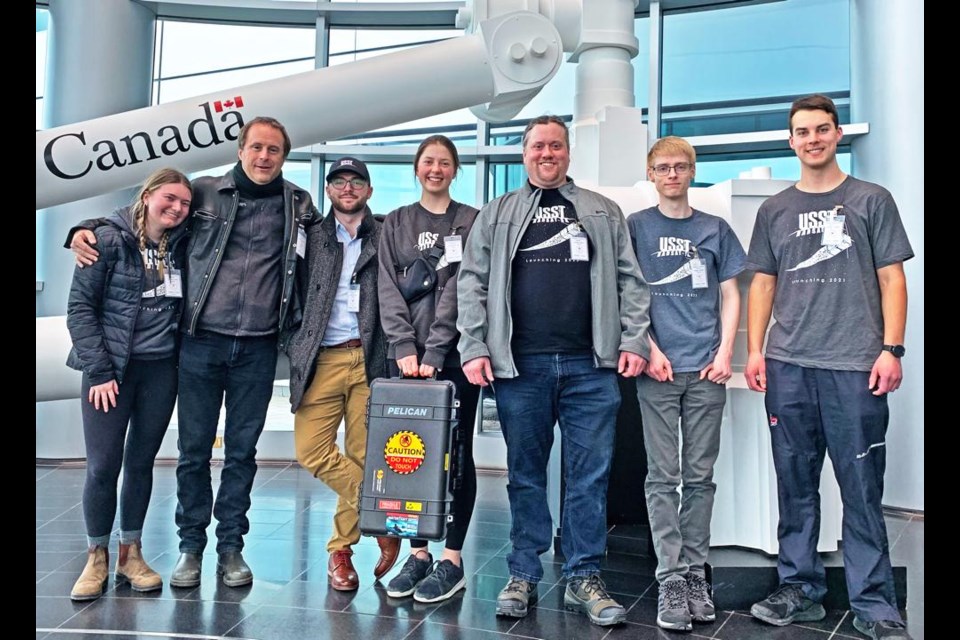 The Space Design Team from the University of Saskatchewan, including Weyburn engineering student Arliss Sidloski (centre, holding hard-shell case), are shown in the front lobby of the Canadian Space Agency in Montreal. The team brought their cube satellite there for final testing, and to be integrated into a deployer mechanism for launching into space. The satellite will be launched on June 1 from the Kennedy Space Centre in Florida, flown to the International Space Station, and astronauts at the space station will launch it into orbit on July 10.