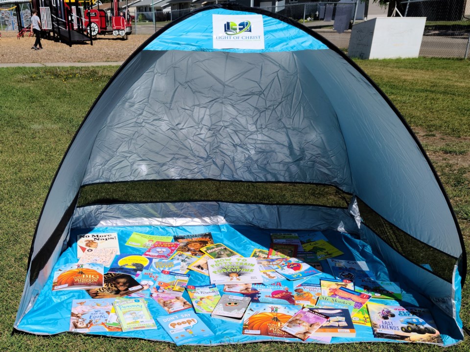TENT WITH BOOKS PAGES IN PARK