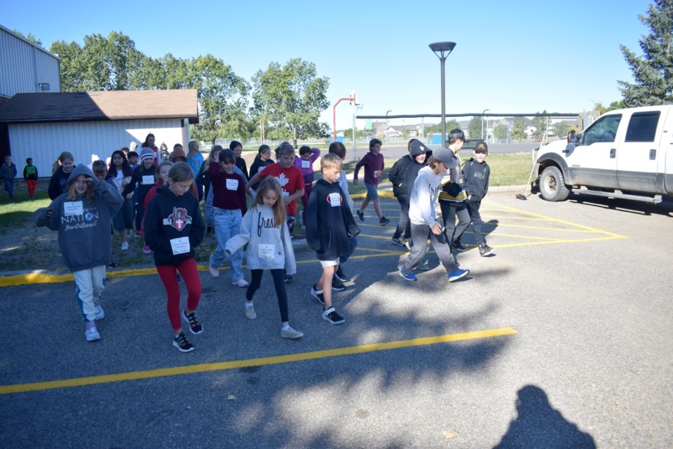 Students from Sacred Heart School/École Sacrè Coeur depart for the start of the school’s Terry Fox Run.