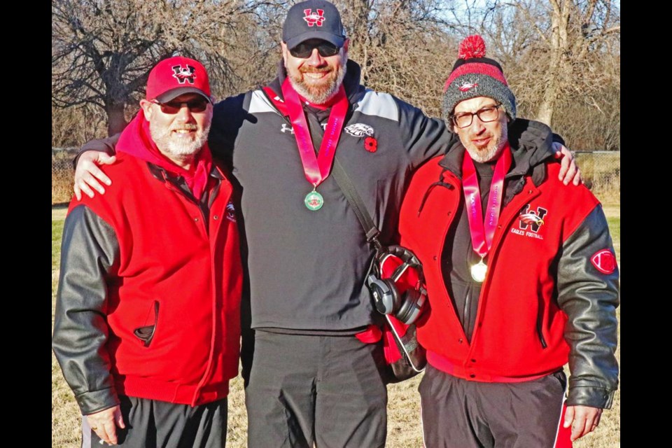 Weyburn Comp Eagles football coaches Darren Abel, Michael Hoffman and Chris Michel celebrated the provincial championshp of the football team on Nov. 11, with all three now stepping back from the coaching staff. Abel is retiring as a teacher, and brought Michel on board 27 years ago, and Hoffman about 24 years ago. Abel and Hoffman served as coaching consultants this season, and were observers in the booth, relaying information to the coaches on the sidelines.