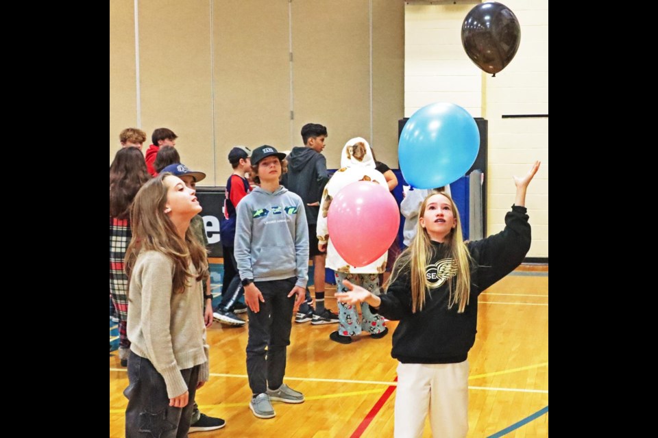 Students had to keep three balloons in the air for a minute at this game station.