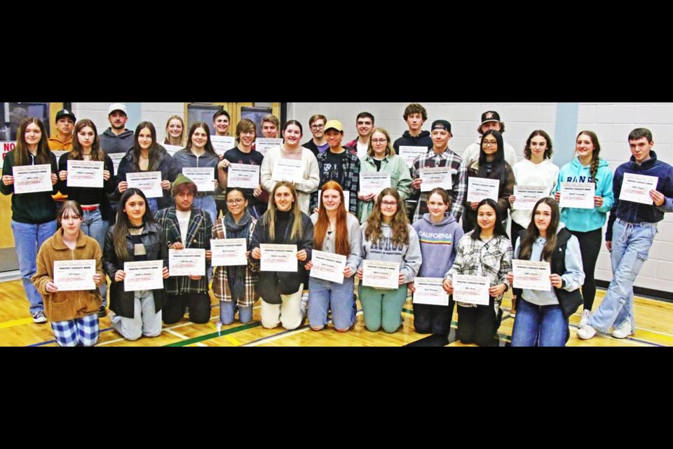 Last year's Grade 11s who received the Principal's Awards of Excellence, for an average of 90% or better for the year, gathered with their certificates on Wednesday. See the story for the full list of recipients.