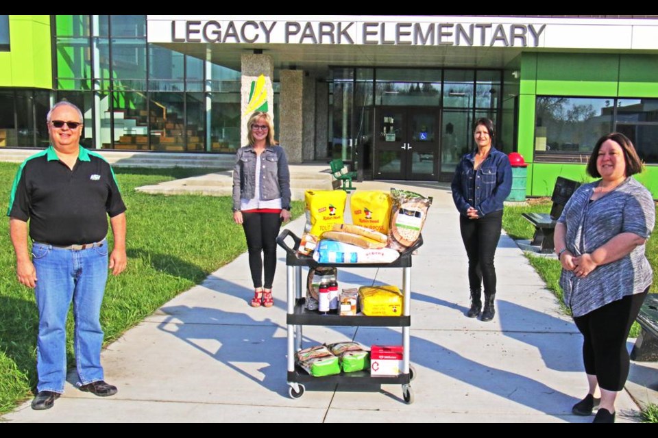 Western Financial representatives brought the ingredients for muffins along with a $1,000 donation to Legacy Park for their nutrition program.