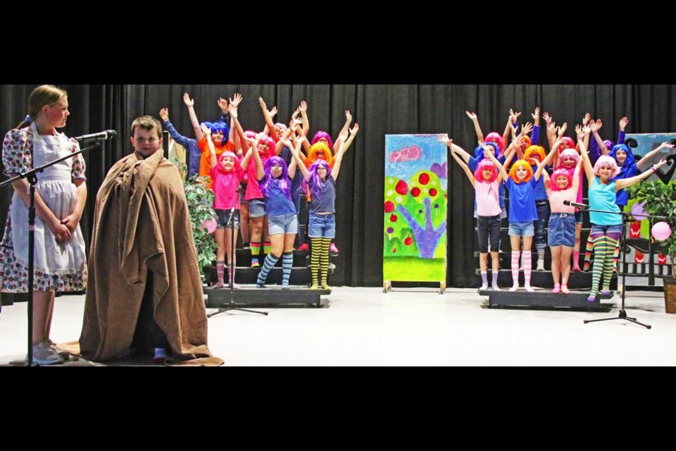 The Oompa-Loompa chorus do the finale of their song, in this scene from Willy Wonka Jr. at Legacy Park school.