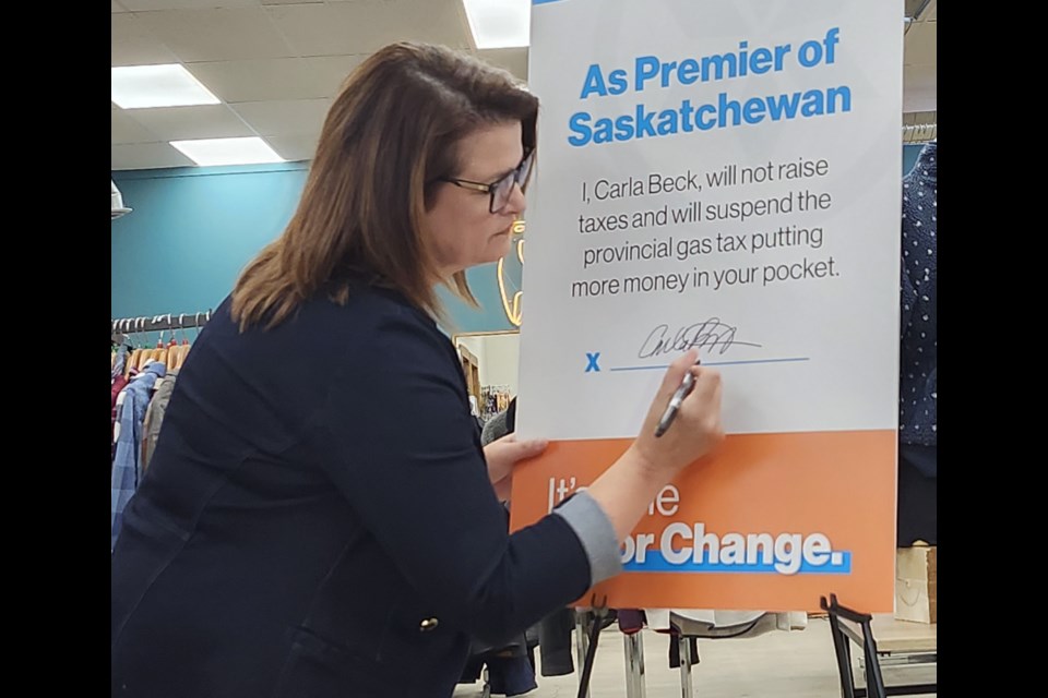 Carla Beck affixes her signature to show her commitment to fulfilling their tax plans. 