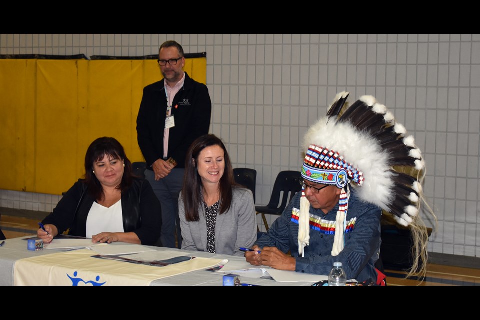 Signing the education service agreement between Cote First Nation and the Good Spirit School Division (GSSD) during a ceremony held at Kamsack Comprehensive Institute on Oct. 11, from left, were: Quintin Robertson (standing), director of education for GSSD; Delvina Whitehawk, councilor for Cote First Nation; Jaime Johnson, GSSD board chair, and Chief George Cote of Cote First Nation.