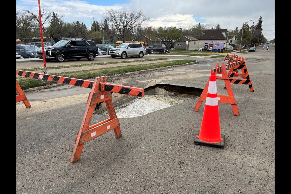  A large sinkhole has formed on the north side of 16th Avenue following a water main break overnight. 