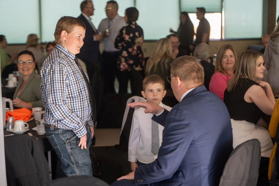 2) Premier Scott Moe chatted with Luke and Reed Vandenhurk at the chamber 120th banquet. 