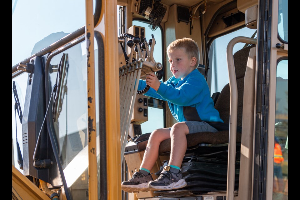 Sounds of horns honking, children on loud speakers and giggles filled the air as another successful Meet-a-Machine event took place at the InnovationPlex this year. Many families attended. Here, youngsters are trying out the grader.