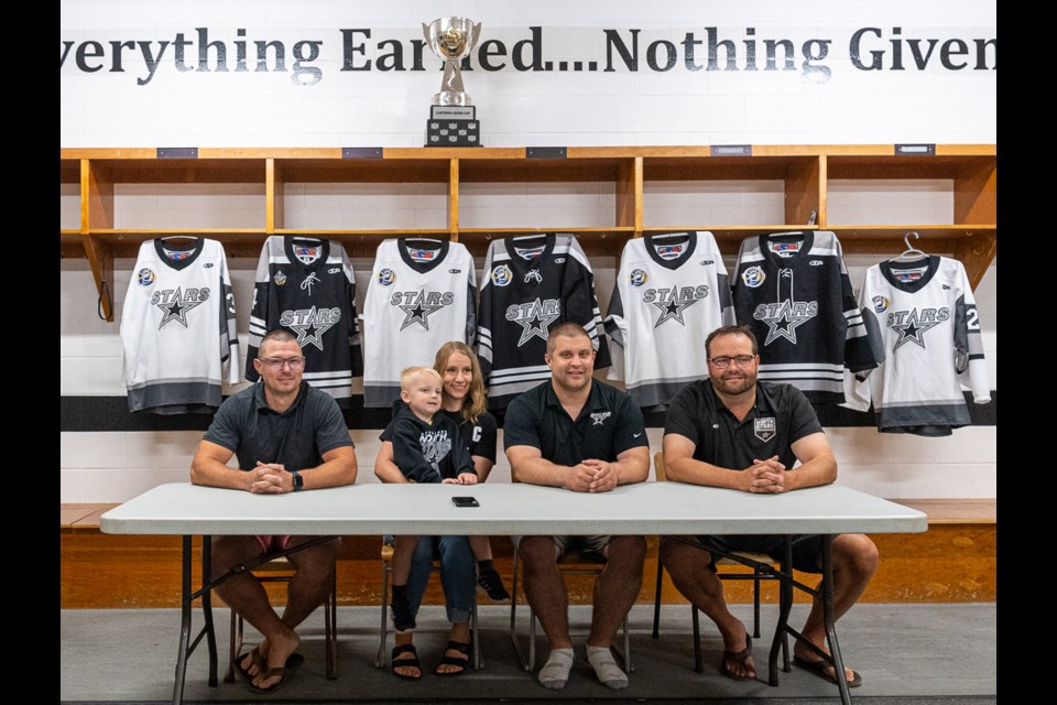 Battlefords North Stars vice-president Mitch Hawtin, Brayden Klimosko's fiance Katlyn, son Jake, Klimosko and Kyle Kellgren, North Stars president, at a press conference Thursday morning in the North Stars dressing room.