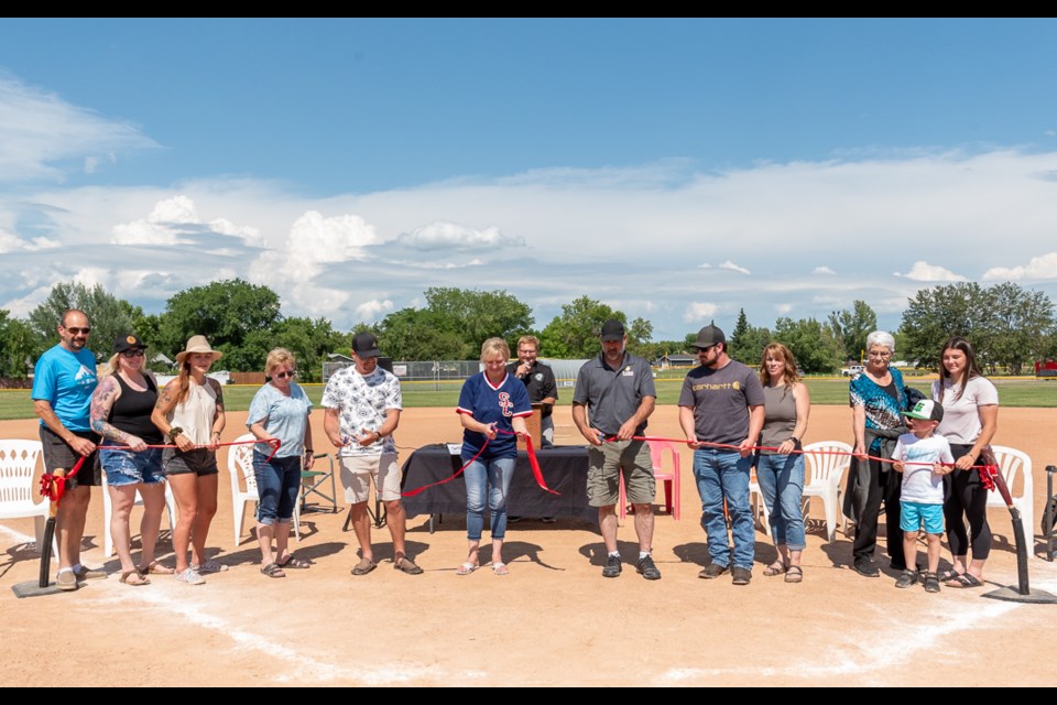 Cutting the ribbon to officially name the number 4 diamond in North Battleford as Al Keller Field.