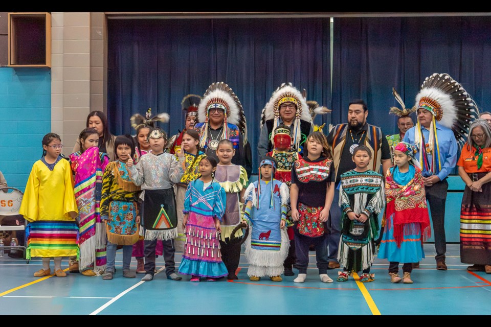 Children come up to the front for a prayer during the ceremony marking the sod-turning for a new school at Sweetgrass First Nation.