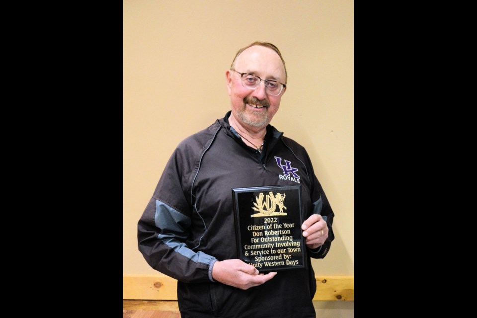 Don Robertson is all smiles, proudly displaying his plaque after being named the 2022 Unity Citizen of the Year.