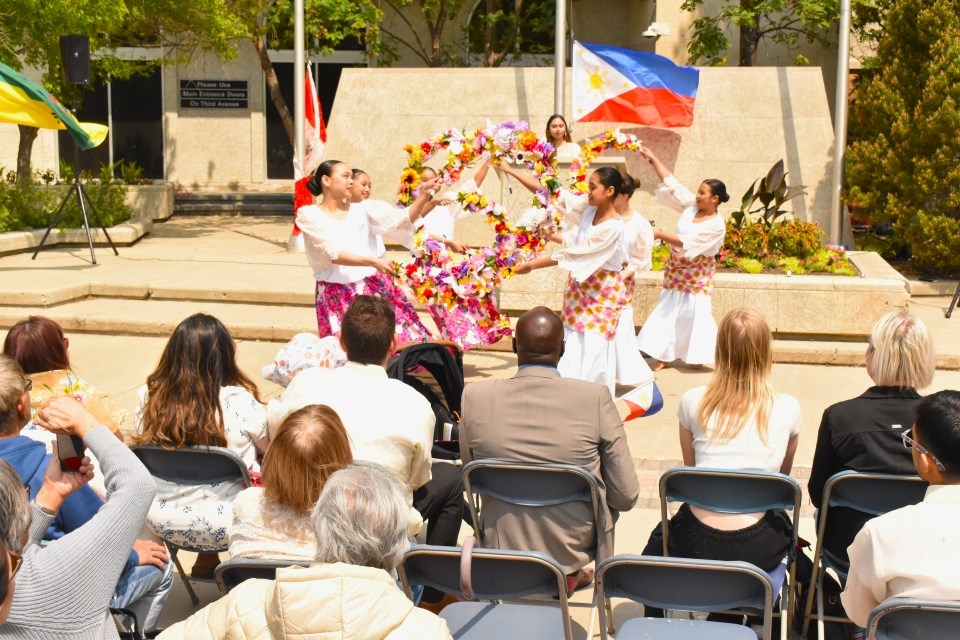 Members of the Kumintang Folk Dance Ensemble perform the Bulaklakan (dance of floral garlands) during the flag-raising ceremony to begin the celebration of Filipino Heritage Month on Sunday, June 8, at the Civic Square.