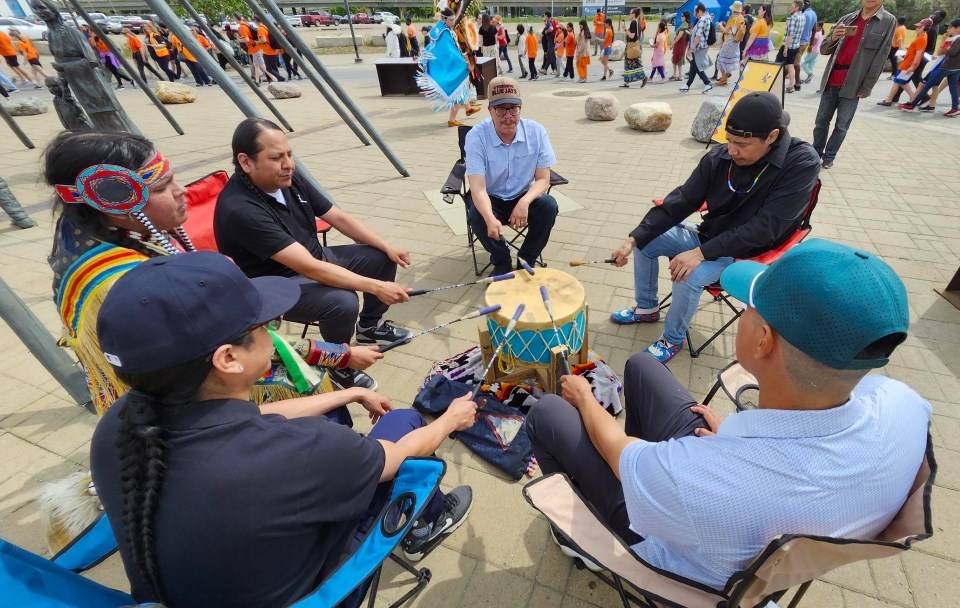 Douglas Morin, top right, performs with the NWA Drum Group at the 2025 Rock Your Roots Reconciliation Walk.
