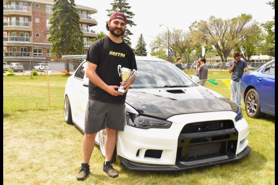 Event organizer and Walter Murray Collegiate alumnus Jon Korolis poses with his 2014 Mitsubishi Lancer Evolution before leaving to join another car show in Edmonton.