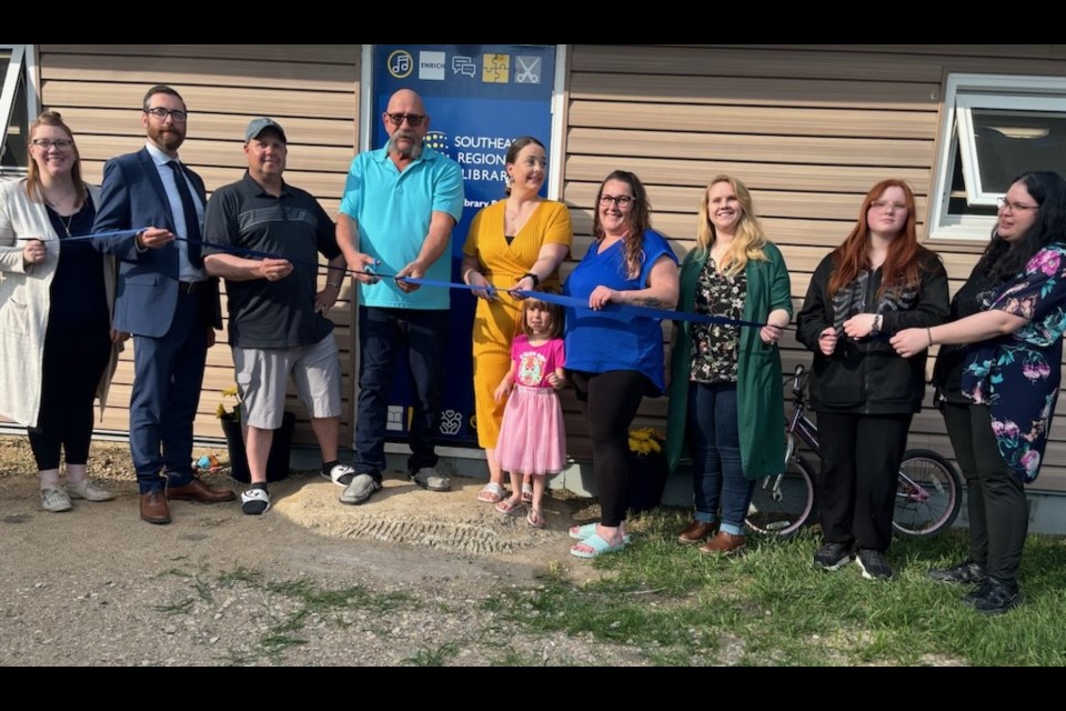 Participating in the ribbon cutting were, from left, Vanessa Lund, James Richards, Gregg Prawdzik, Al Hauglum, Desiree Simpson, Zoey Simpson, Jeri-Lee Jones, Lois Feaver, Melanie Braun and Becky Schofield. 