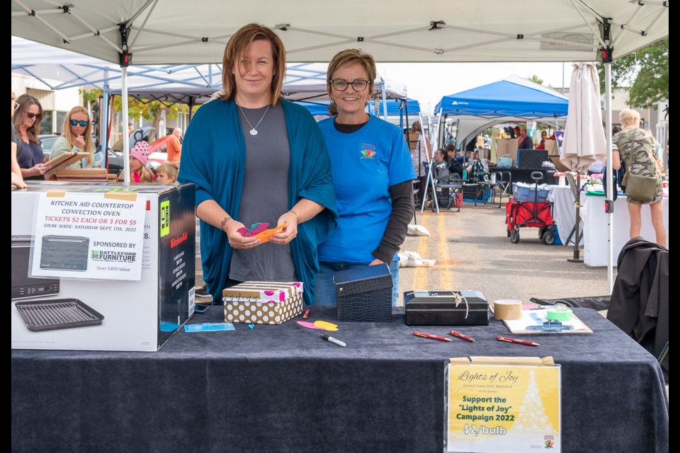 Suzanne Reid and Judy Pruden, two of the many members of the Battleford Community Spirit Group, sold tickets for the raffle as well as selling lights for the Lights of Joy trees in theLions park at Christmas.