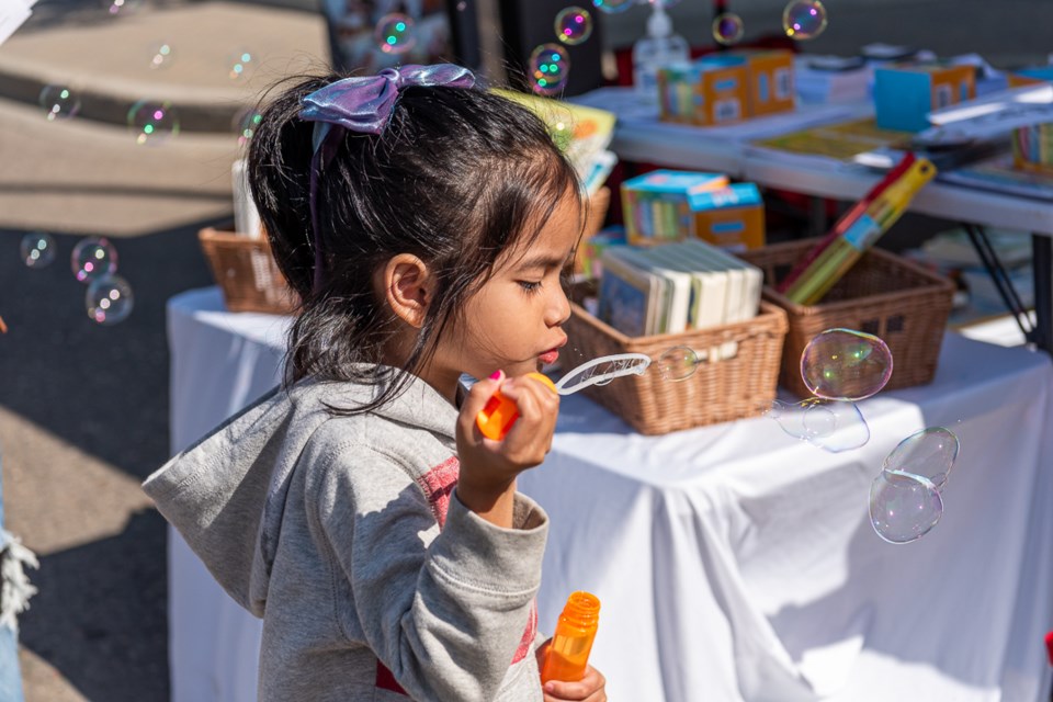 A little girl was delighted to get a container uf bubbles from The Treaty 6 Health Centre.