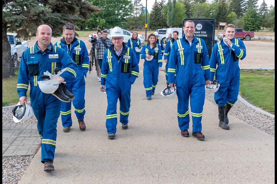 Employees from Strathcona Resources arrive at the Western Development Museum in North Battleford for a press conference.