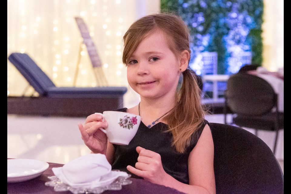 Brielle Sittler practiced holding her tea cup with her pinky out.