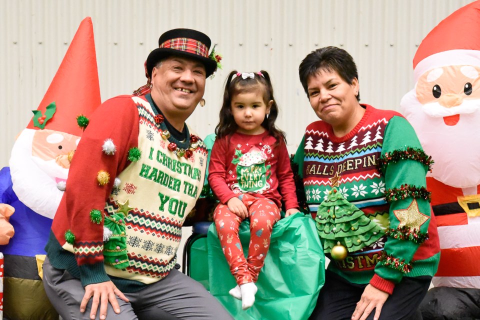 Shawna and Cori Arcand brought their daughter Jordan, all wearing their Christmas sweaters) to see Santa Claus.