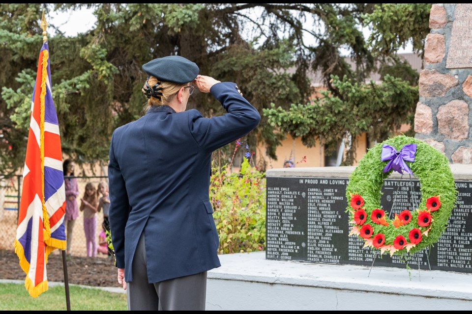 Esther Delainey salutes after she lays the wreath to honour Queen Elizabeth II.