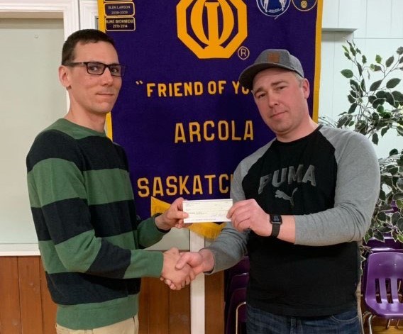 Arcola Mayor Scott Tessier was presented with a cheque for $8,000 from Optimist Snowmobile Rally chairman Geordan Workman. 