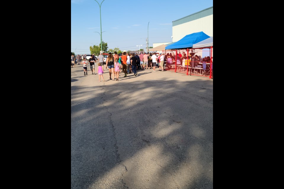 Behind this big lineup, worked the Kerrobert Kinsmen cooking up food and serving refreshments as part of a summer event held in the community, Aug. 16.