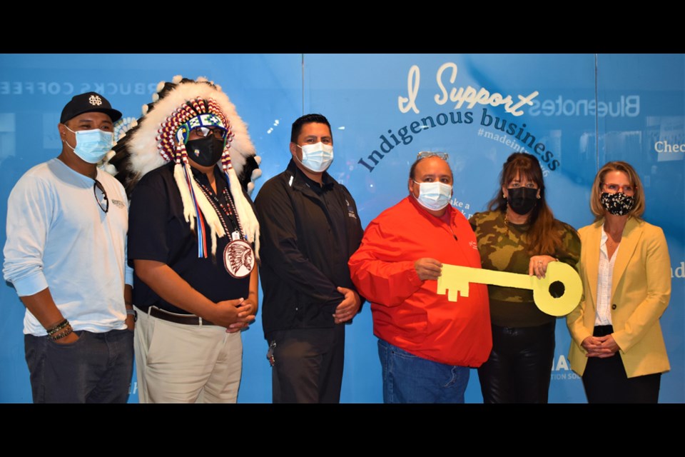 Battlefords Agency Tribal Chiefs Executive Director Neil Sasakamoose, fourth left, receives the ceremonial key for the Nikihk store from Midtown Plaza specialty leasing manager Linda Young. Others in photo are, from left, Cree language translator Randy Morin, Federation of Sovereign Indigenous Nations Second Vice-Chief David Pratt, Moosomin First Nation Chief Brad Swiftwolfe and Midtown Plaza general manager Janice Sander.