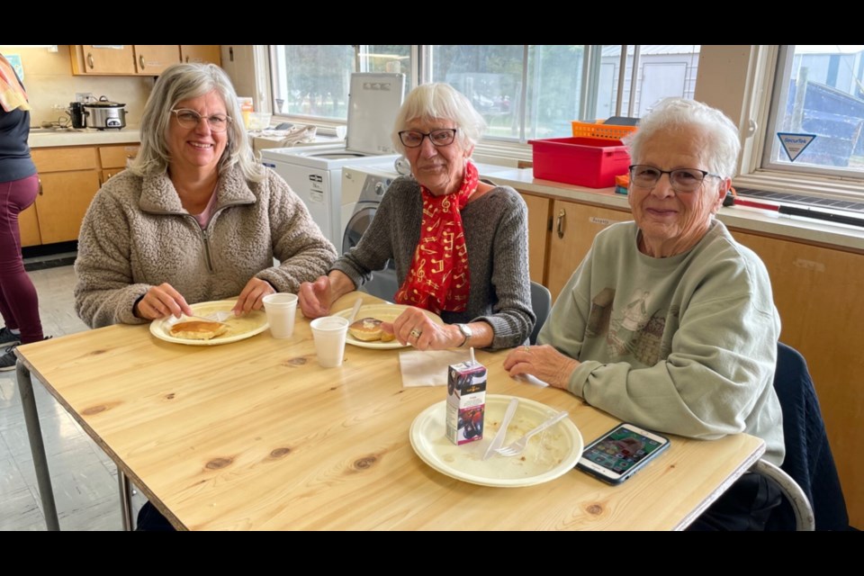 Kim Kehrig, Peggy Looby and Margaret McKeith grabbed a bite to eat at Bjorkdale School's annual school breakfast.