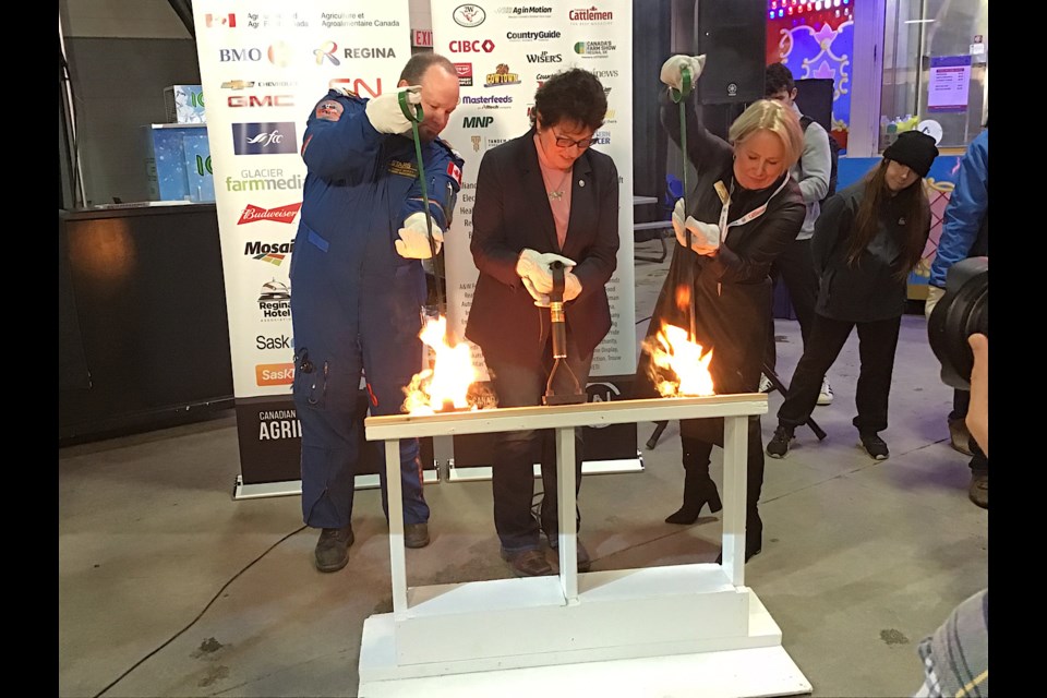 STARS’ Darcy McKay, CWB President Kim Hextall and STARS CEO Andrea Robertson take part in the Burning of the Brand