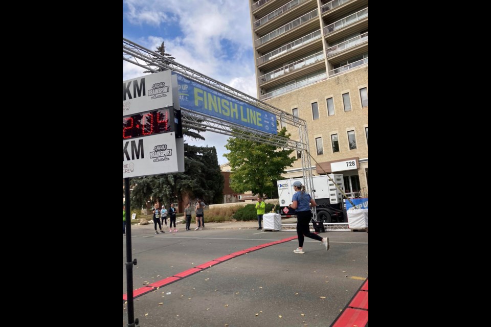 Former Unity resident, Lauren Wallace, crosses the finish line of the 21k portion of the Cameco Step Up marathon held Sept. 24 in Saskatoon.