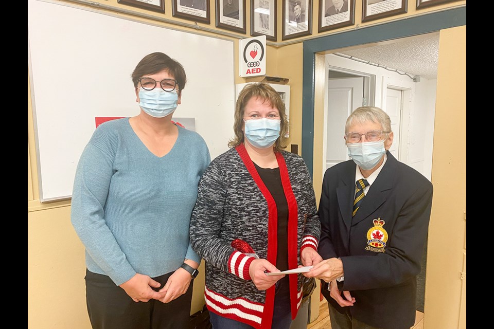 Representing the Moose Mountain Lodge, Bertha Isleifson and Candy Bye, accepting a cheque from Wendy Rounce