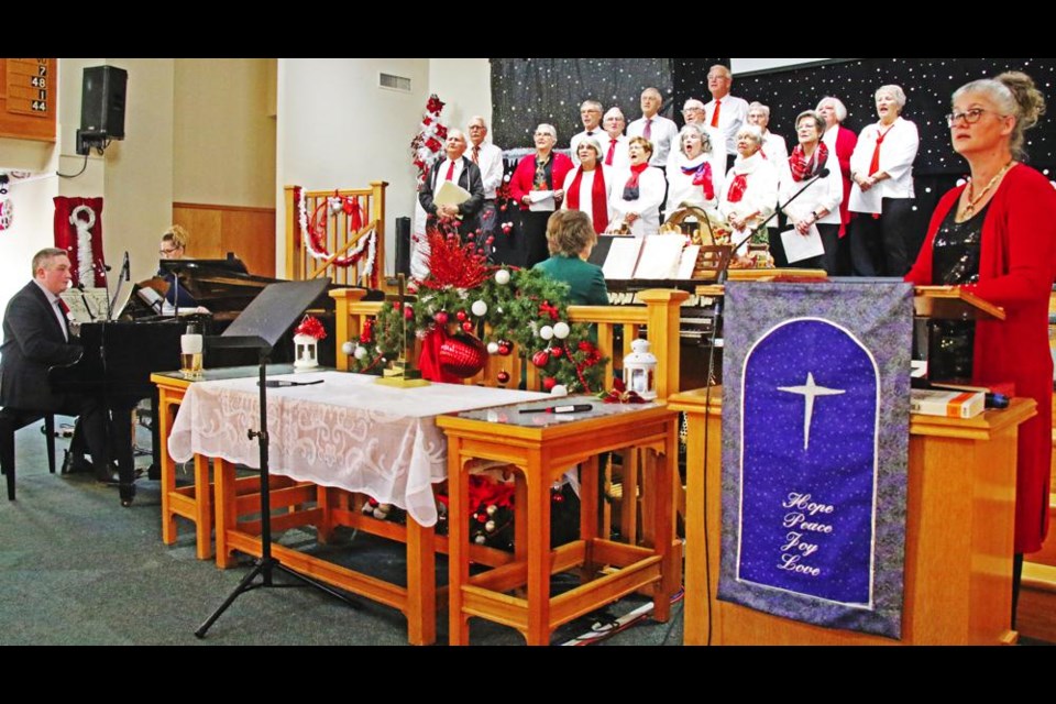 Emcee Heather Sidloski, at right, and members of the Weyburn Rotary Club led the community carol singing at the start of the Carol Festival on Sunday at Grace United Church.