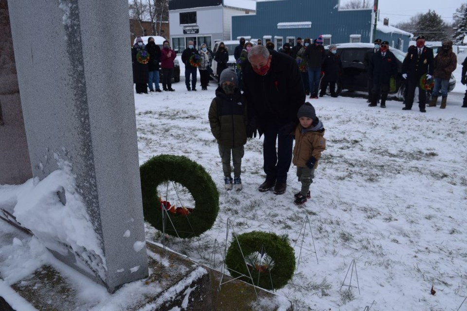 The annual Remembrance Day service was held at the Canora Cenotaph on November 11. Canora-Pelly MLA Terry Dennis laid a wreath as a representative of the Provincial Government, while giving his grandsons Lewis (left) and Oliver Ostapowich a close-up look at the importance of Remembrance Day. / Rocky Neufeld