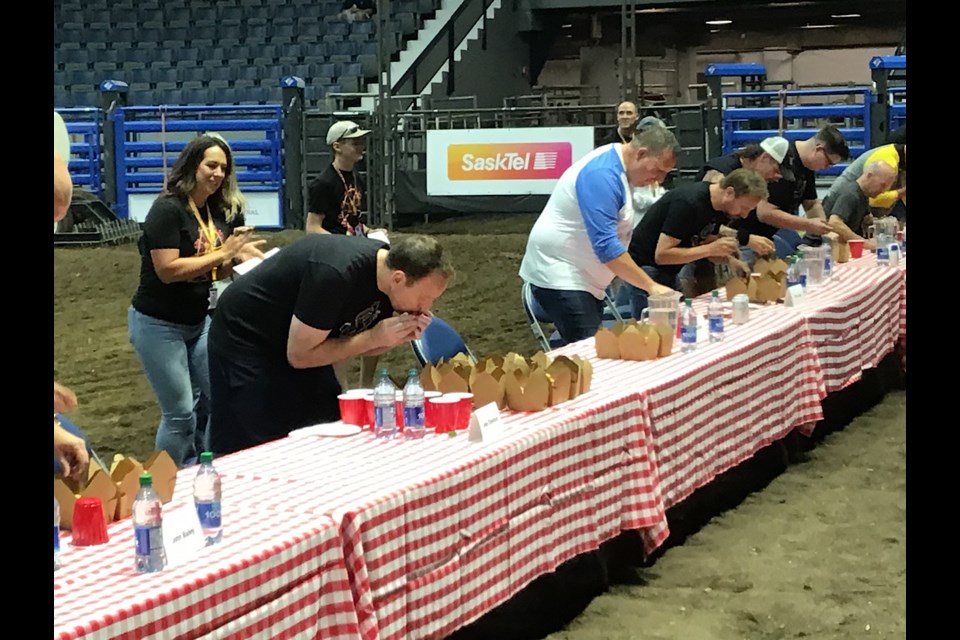They’re off and running at the Queen City Ex mini-doughnut eating competition at Brandt Centre Aug. 5.
