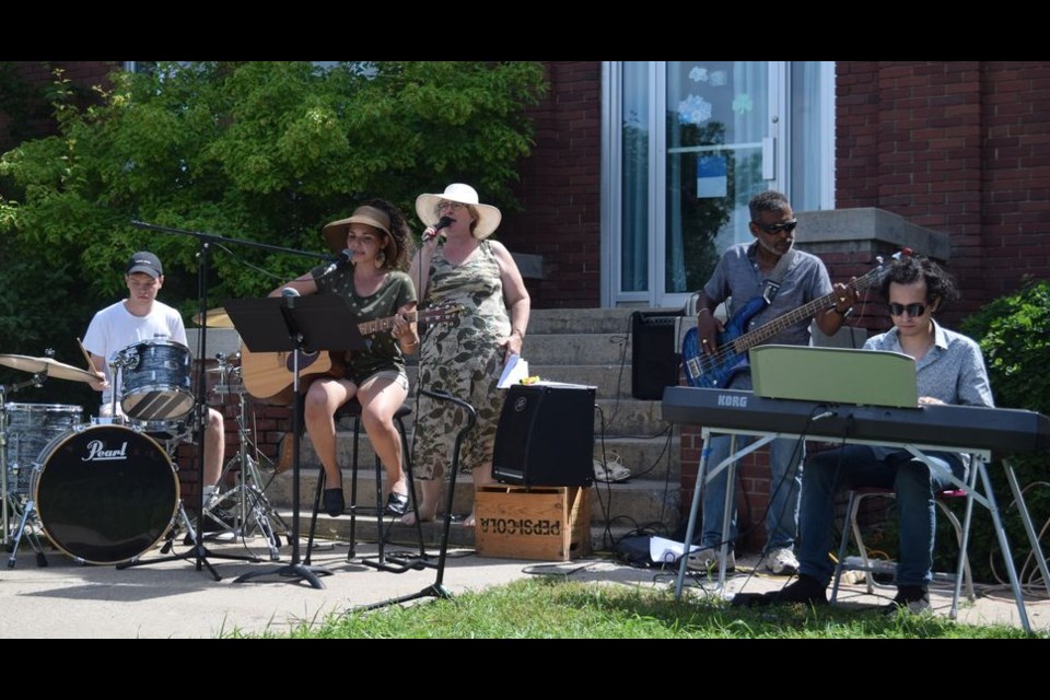 The worship band led a time of spirited signing at the community church service outside the Town Hall on July 17. From left, were: Elijah Debnam on drums, Carissa Schomburg on vocals and guitar, Cheryl Senechal on vocals, Dwaine Senechal on bass, and Caleb Senechal playing keyboards.