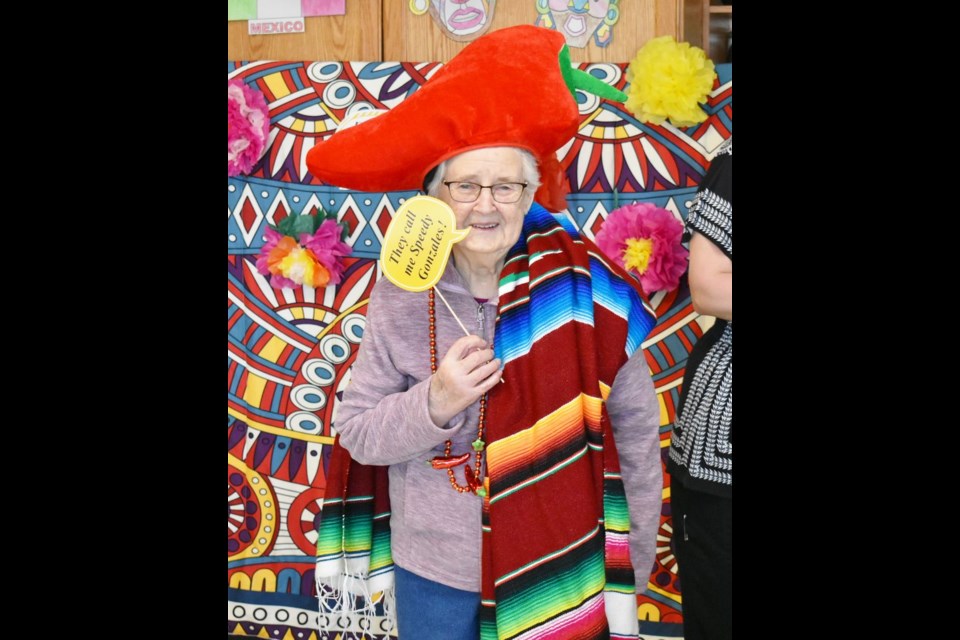 Modeling a stunning red chili pepper hat and matching necklace with style was resident, Annie Kinaschuk.