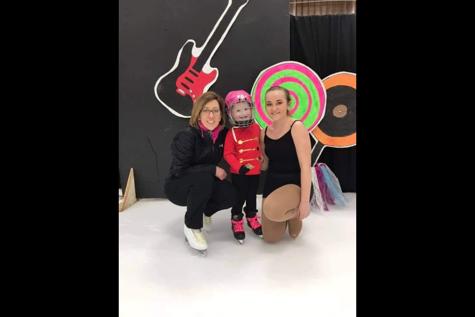 Colleen Smith, long-time coach at the Unity Skating Club poses with a student and her oldest daughter at a past carnival.