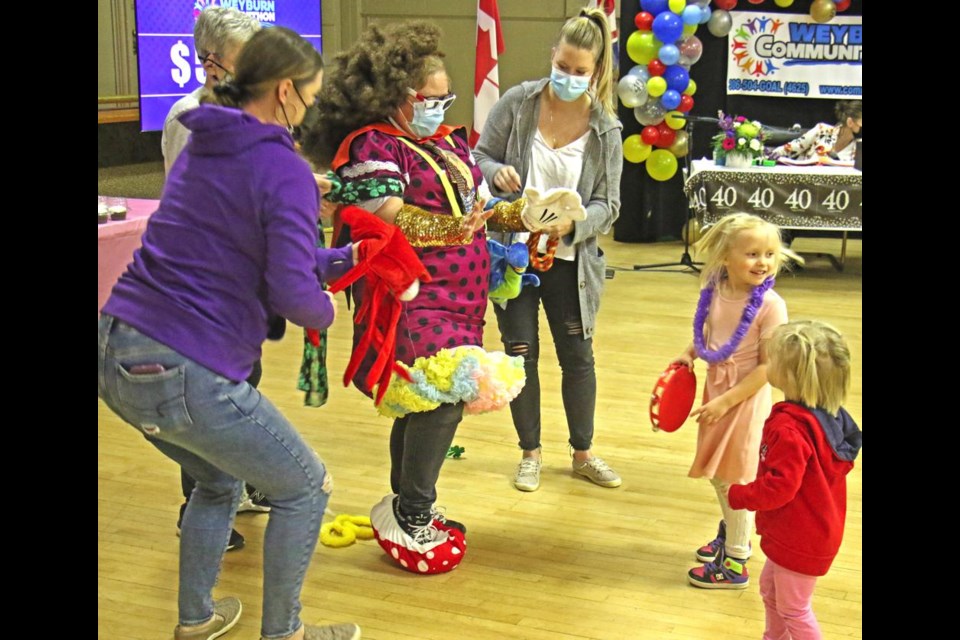 Communithon chairperson Korryn Kubashek was dressed up in a variety of colourful remnants by volunteers, as her two granddaughters, Avery and Abby, watched in fascination on Friday evening.
