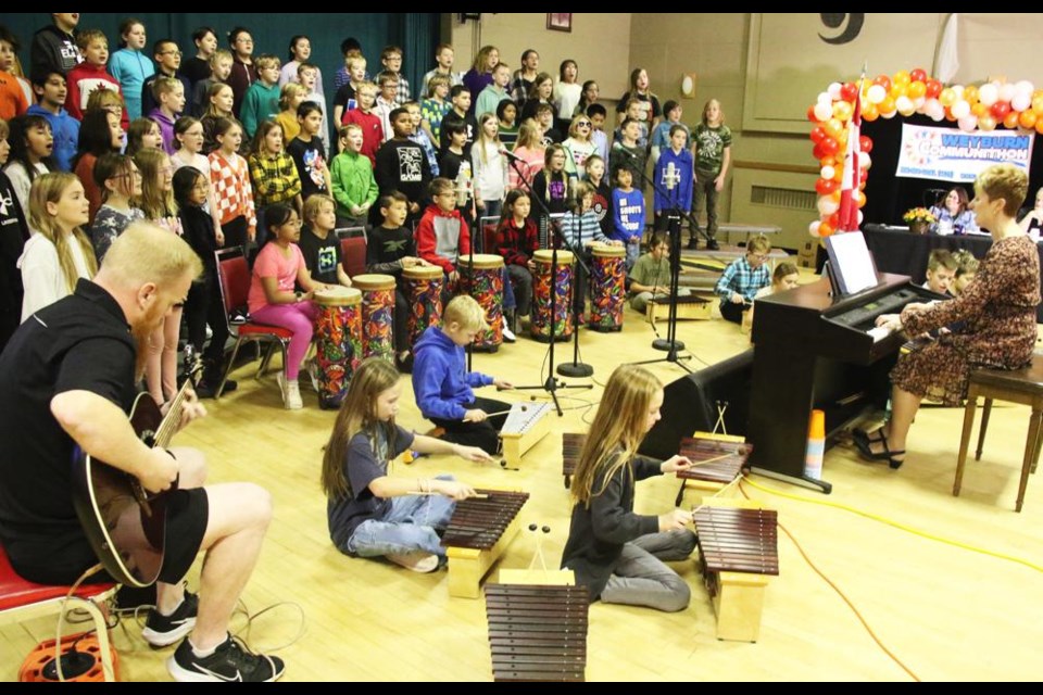 The Grade 5 choir from Legacy Park Elementary, accompanied by Tyson O'Dell on guitar, xylophones and drums, and led by Holly Butz, performed at Communithon on Friday morning.