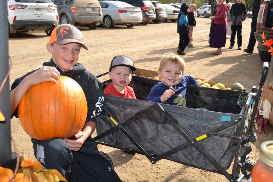 Wyatt Scheller, left, helped Ayven Jakubowski and Odin Vancaeseele with picking out a pumpkin.