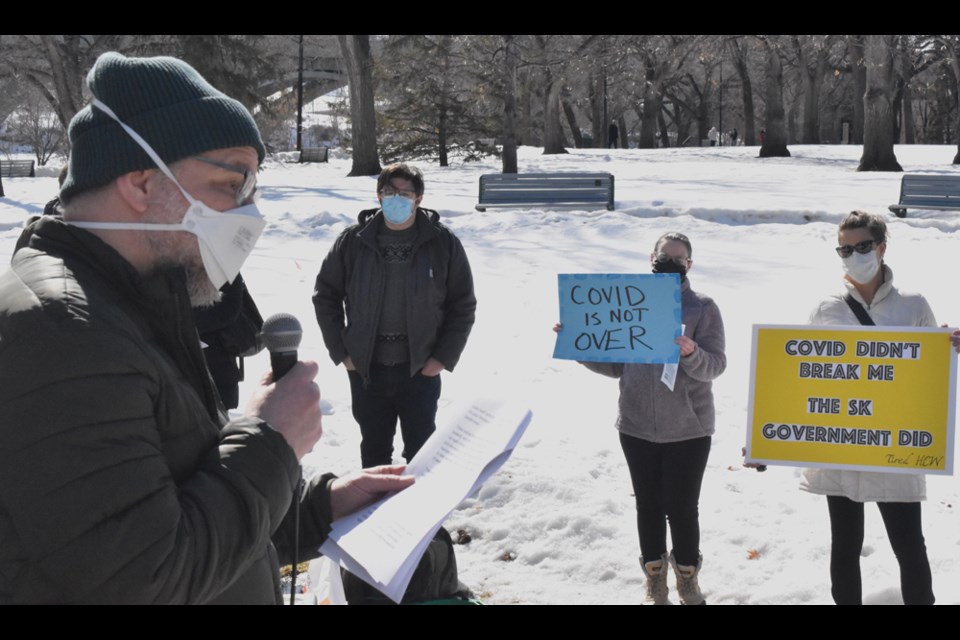 Take Action Against COVID co-organizer Rob Butz speaks to their supporters in Saturday's public event at Kiwanis Park.