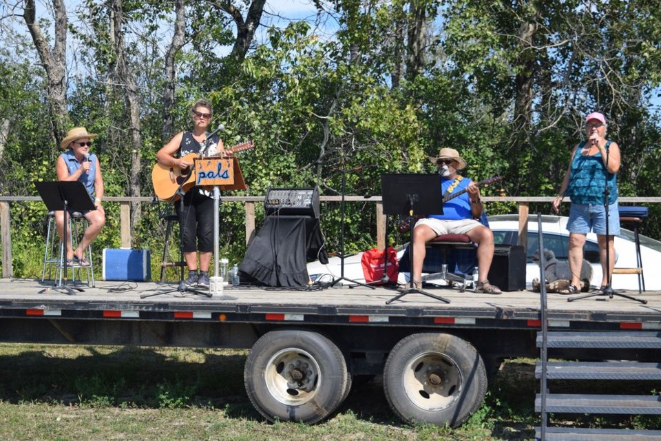 Not far from where the threshing equipment was set up, the Sept. 4 Cowboy Church Service was enriched by the musical contributions of, from left: Nancy Genoway of Rama (vocals), Marilyn Fredsberg of Wynyard (acoustic guitar, vocals), Eugene McKenzie of Wynyard. (bass, vocals) and Judy Johnson of Preeceville (vocals).