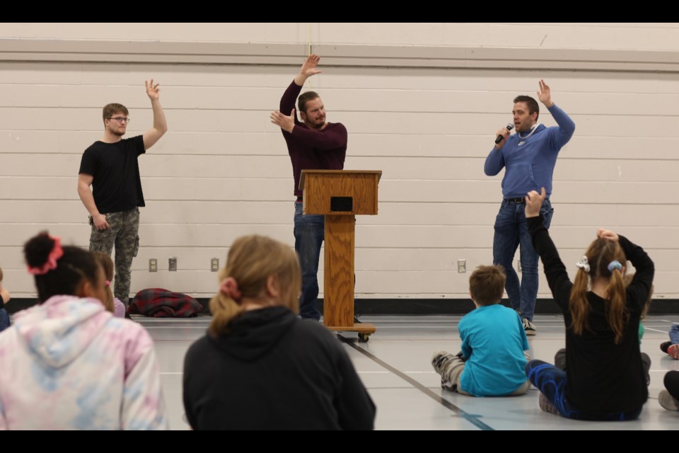Canadian Wrestling's Elite performers Tyler Adams (left), 'The Headline' Shawn Martens (center) and Travis Cole (right) talked to students on April 6 about the negative effects of bullying. Seen here raising their hands in solidarity with others who have suffered from bullying.