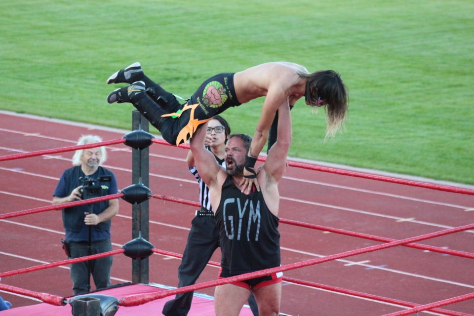 The Canadian Rottweiler poised to deliver a devestating slam on Sol.