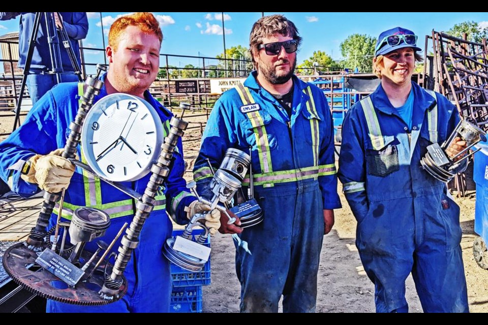 The overall winners of the "Fall Brawl" demo derby, hosted by the Weyburn Ag Society, are from left, Carson Palmer in first (and winner of the Best Dressed award); Dylan Crozier, second, and Mac Metheral in third, with their custom-made trophies and prize money.