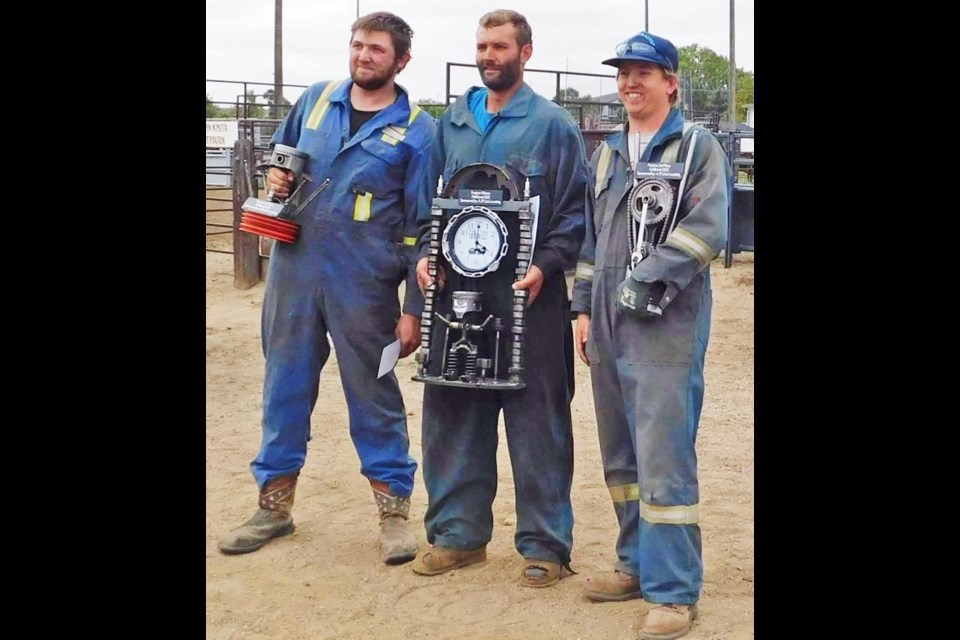 The overall winners of the "Fall Brawl" demo derby were presented with their trophies on Sunday. From left are Colton Dodd, third place; Jarad Bourassa, first place; and Mac Metheral, second.