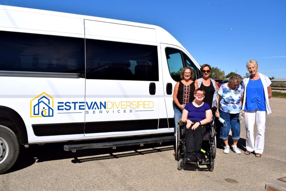 Katrina Mantei, one of the regular users of the van, was joined by EDS board members Susan Colbow, Cindy Billesberger, Margaret Mack and Norma Blackburn, standing in front of the new van with a new logo.